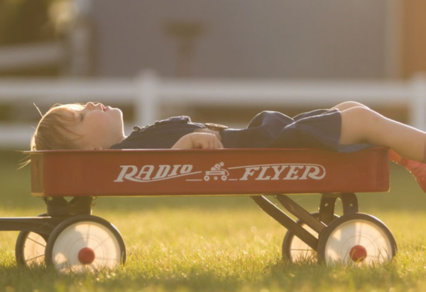 child lying in wagon