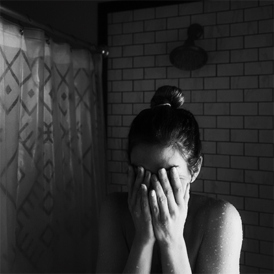 woman shower restroom grief